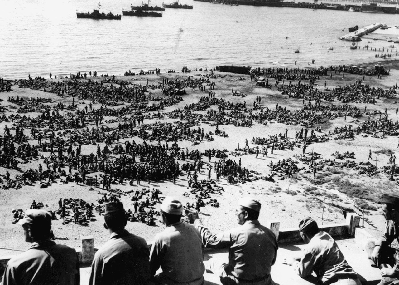 Thousands of US troops waiting on an Italian beach to board landing craft for Southern France.