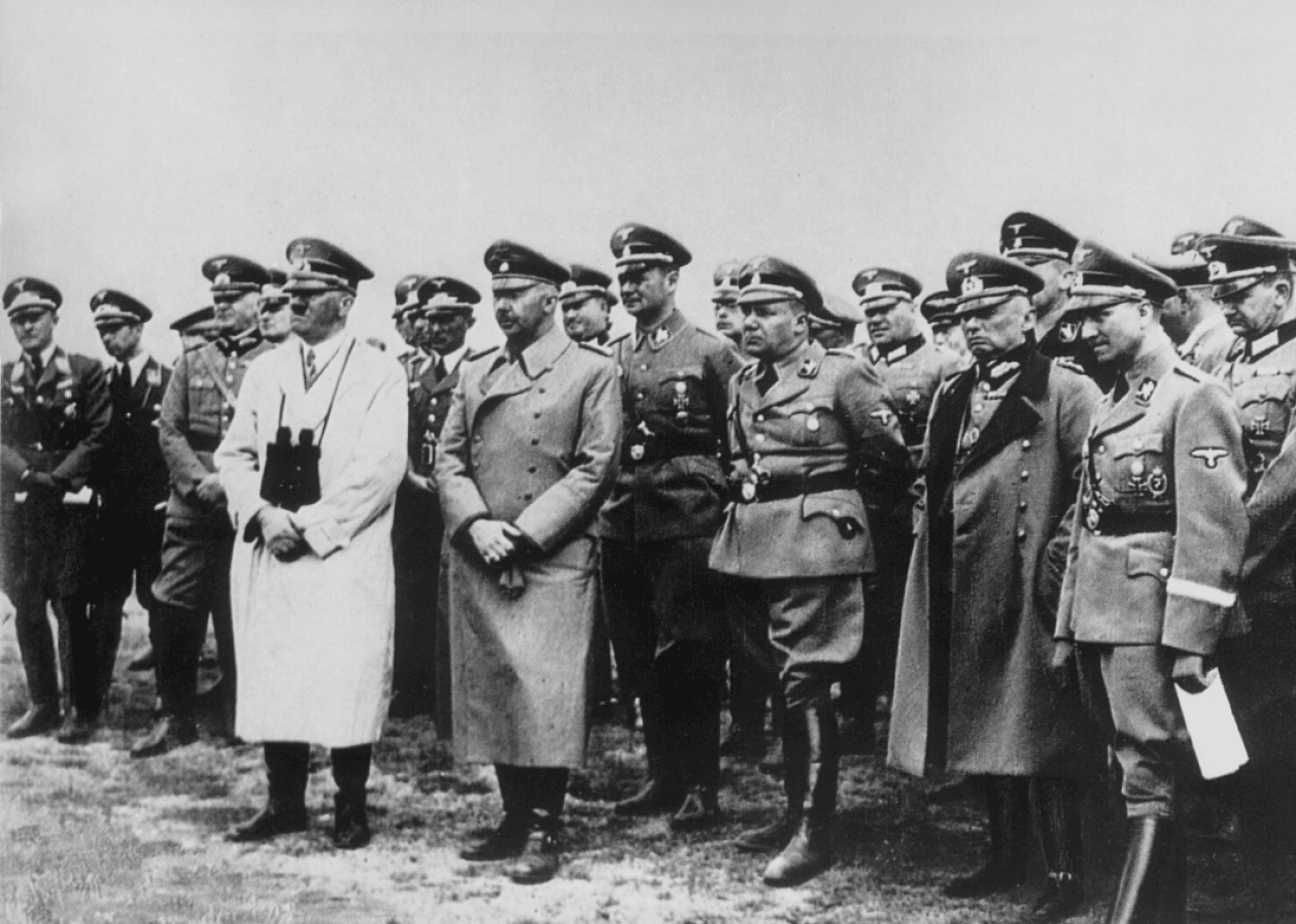 Nazi leader Adolf Hitler stands with Heinrich Himmler and staff while looking across the English Channel from Calais in August 1940.