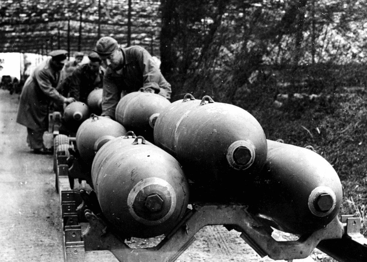 Soldiers load 2,000-pound bombs on aircraft in England prior to D-Day.