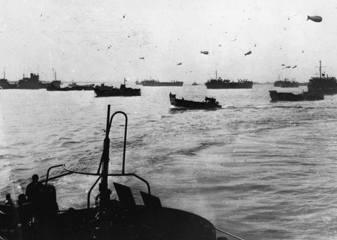 Allied landing craft protected by barrage balloons cross the English Channel on June 6, 1944.